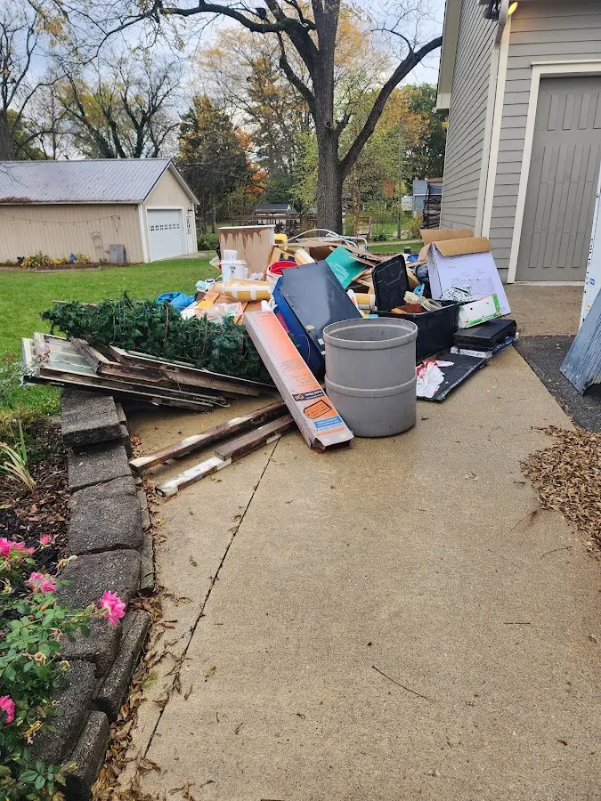 Dumpster being loaded with debris for Estate Cleanout Dumpster Rental in Garfield